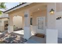 Covered front porch with stone columns and decorative lighting fixtures at 9709 Casper Peak Ct, Las Vegas, NV 89117