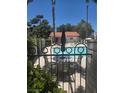 Community pool with poolside seating, surrounded by mature trees, offering a perfect spot for relaxation at 101 Luna Way # 104, Las Vegas, NV 89145