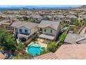Aerial view of the backyard oasis with pool, spa, and covered patio in a Gathering-friendly neighborhood at 11844 Mino Rio Ave, Las Vegas, NV 89138