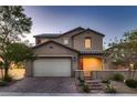 Charming two-story home with a brick driveway and well-manicured front yard at 11844 Mino Rio Ave, Las Vegas, NV 89138