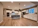 Modern kitchen featuring white cabinets, stainless steel appliances, and a unique island design at 11844 Mino Rio Ave, Las Vegas, NV 89138