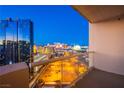 Balcony view overlooking the Las Vegas cityscape, with clear railings offering unobstructed views of the vibrant city at 125 E Harmon Ave # 2801 & 2803, Las Vegas, NV 89109