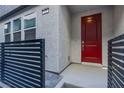 Charming front entrance features a vibrant red door and stylish black horizontal fence at 139 Aqua Commons Ln, Henderson, NV 89015