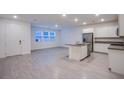 Bright, open-concept kitchen features stainless steel appliances, an island, and tile floors at 139 Aqua Commons Ln, Henderson, NV 89015