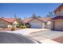 Inviting single-Gathering home featuring a tile roof, landscaped front yard, and two-car garage at 1590 Desertaire Way, Las Vegas, NV 89110