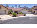 Beautiful home with desert landscaping, a tile roof, and attached garage in a quiet neighborhood at 1590 Desertaire Way, Las Vegas, NV 89110