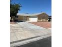 Cozy single-story home featuring an attached two-car garage, neutral paint and low maintenance landscaping at 1809 Lamplighter Ln, Las Vegas, NV 89104