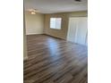 Inviting living room featuring new wood flooring and bright natural light through sliding glass door and window at 1809 Lamplighter Ln, Las Vegas, NV 89104