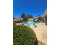 Inviting community pool featuring lounge chairs, umbrellas, and clear blue water for relaxation and enjoyment at 1908 Rio Canyon Ct # 105, Las Vegas, NV 89128