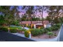 Inviting home exterior with manicured landscaping, modern gate, and well-lit pathway at 200 Stonewood Ct, Las Vegas, NV 89107