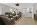 Open-concept living area featuring sleek floors, modern furnishings, and ample natural light perfect for relaxing and entertaining at 2084 Airy Petals Walk, Henderson, NV 89044