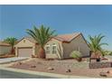 Lovely home featuring desert landscaping with palm trees and a decorative stone retaining wall at 2217 Merrimack Valley Ave, Henderson, NV 89044