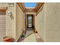 Inviting covered entryway leading to an attractive front door with decorative glass accents at 2217 Merrimack Valley Ave, Henderson, NV 89044