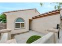 Inviting entrance with covered porch, tiled roof, and desert landscaping in a well-maintained front yard at 2766 Mintlaw Ave, Henderson, NV 89044