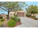 Charming single-story home with desert landscaping and a two-car garage on a sunny day at 2766 Mintlaw Ave, Henderson, NV 89044