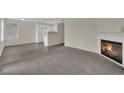 Open-concept living space with fireplace, wood floors, and seamlessly integrated kitchen at 3182 Tarpon Dr # 204, Las Vegas, NV 89120