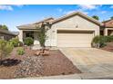 Charming single-story home featuring a two-car garage and low maintenance desert landscaping at 3257 Rushing Waters Pl, Las Vegas, NV 89135