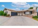 Single story home featuring a two car garage and drought resistant landscaping at 3499 Middlebury Ave, Las Vegas, NV 89121