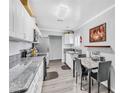 Clean, bright kitchen with stainless steel appliances, stone countertops and eat in dining area at 3499 Middlebury Ave, Las Vegas, NV 89121
