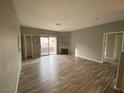 Spacious living room with wood floors and sliding glass doors to the balcony at 4730 E Craig Rd # 1149, Las Vegas, NV 89115