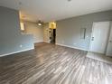 Open-concept living area with a ceiling fan, wood floors, and modern paint at 4730 E Craig Rd # 1149, Las Vegas, NV 89115