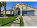 Charming single-story home with a well-manicured lawn, desert landscaping, and attached garage at 5025 Chambliss Dr, Las Vegas, NV 89130