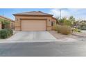 A lovely single-story home featuring a two-car garage and desert landscaping at 6061 Moonlight Sonata Ave, Las Vegas, NV 89122