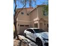 Exterior view showcasing a well-manicured lawn and a modern two-car garage and new sedan at 8355 Pearl Beach Ct, Las Vegas, NV 89139