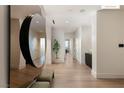 Bright foyer with hardwood floors, modern mirror, and minimalist decor create an inviting space at 11660 Summit Club Dr # 204, Las Vegas, NV 89135