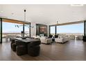 Open-concept living and dining area with panoramic views and stylish, contemporary furniture at 11660 Summit Club Dr # 204, Las Vegas, NV 89135