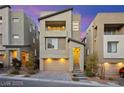 Modern three-story home with two-car garage and desert landscaping at 11676 Midnight Melody Ave, Las Vegas, NV 89138