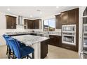 Gourmet kitchen with granite counters, stainless appliances and island seating at 11676 Midnight Melody Ave, Las Vegas, NV 89138
