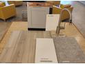 Close-up of interior design materials, featuring flooring samples, cabinetry, and fixture finish options at 1529 Little Penguin St, Las Vegas, NV 89138