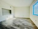 A well-lit living room showcases wood-look floors and ample sunlight from a bright window at 1881 W Alexander Rd # 2117, North Las Vegas, NV 89032