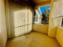 A private patio with a decorative security door offers a cozy outdoor space at 1881 W Alexander Rd # 2117, North Las Vegas, NV 89032