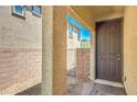 Inviting front entrance with a solid door, brick accents, and tiled welcome mat at 2300 Sky Island Dr, Henderson, NV 89002