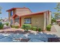 Charming exterior view of the home showcasing the manicured landscaping and mature trees at 2352 Pickwick Dr # 85, Henderson, NV 89014