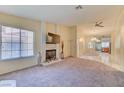Cozy living room featuring a fireplace, large window, and open layout at 2352 Pickwick Dr # 85, Henderson, NV 89014