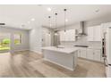 Modern kitchen with island, stainless steel appliances, and access to the private courtyard at 3391 Stone View Ave, Henderson, NV 89044