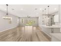 Bright, open-concept living area with hardwood floors and sliding glass doors to a private courtyard at 3391 Stone View Ave, Henderson, NV 89044