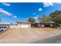 Quaint single-story home with desert landscaping, a covered patio, and a two-car garage at 405 Box Elder Way, Henderson, NV 89015