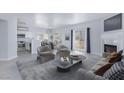 Inviting living room with modern furnishings, a fireplace, and sliding glass doors to the outside at 4820 Grey Wolf Ln # 101, Las Vegas, NV 89149