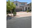 Charming two-story home with a tile roof, arched entry, and a two-car garage at 600 Our Heritage St, Henderson, NV 89011