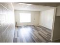 Bright living room features wood-style floors and a large window at 605 S Royal Crest Cir # 8, Las Vegas, NV 89169