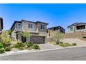 Stylish home featuring a two-car garage and a low-maintenance landscaped front yard at 689 Rogue Wave St, Las Vegas, NV 89138
