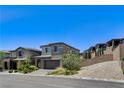 A modern two-story home with desert landscaping on a sunny day at 689 Rogue Wave St, Las Vegas, NV 89138