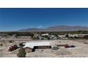 Expansive property featuring a home, RV, vehicles, and mountain views at 7130 Bilpar Rd, Las Vegas, NV 89131