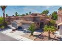 Beautiful two-story home featuring a tile roof, desert landscaping, and a spacious driveway with a two-car garage at 7329 Restful Springs Ct, Las Vegas, NV 89128
