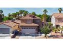 Charming two-story home with a well-maintained lawn, mature trees, and attached two-car garage at 7329 Restful Springs Ct, Las Vegas, NV 89128