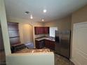 Well-lit kitchen with stainless steel appliances, granite countertops, and dark wood cabinets at 9000 Las Vegas Blvd # 2101, Las Vegas, NV 89123